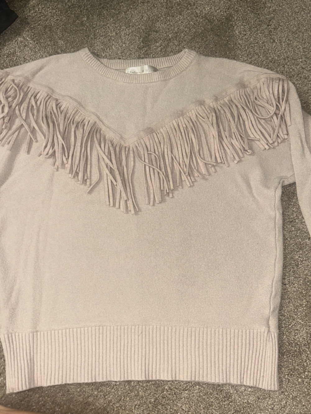 Chelsea & Theodore Off-the-Shoulder Fringe Sweater in Beige